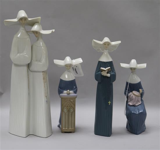 A Lladro group of two nuns and three other figures of nuns, tallest 34cm